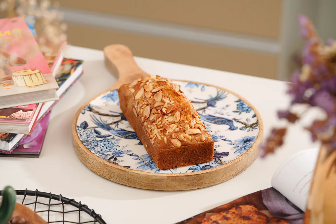 Almond-topped tea cake on a blue and white plate