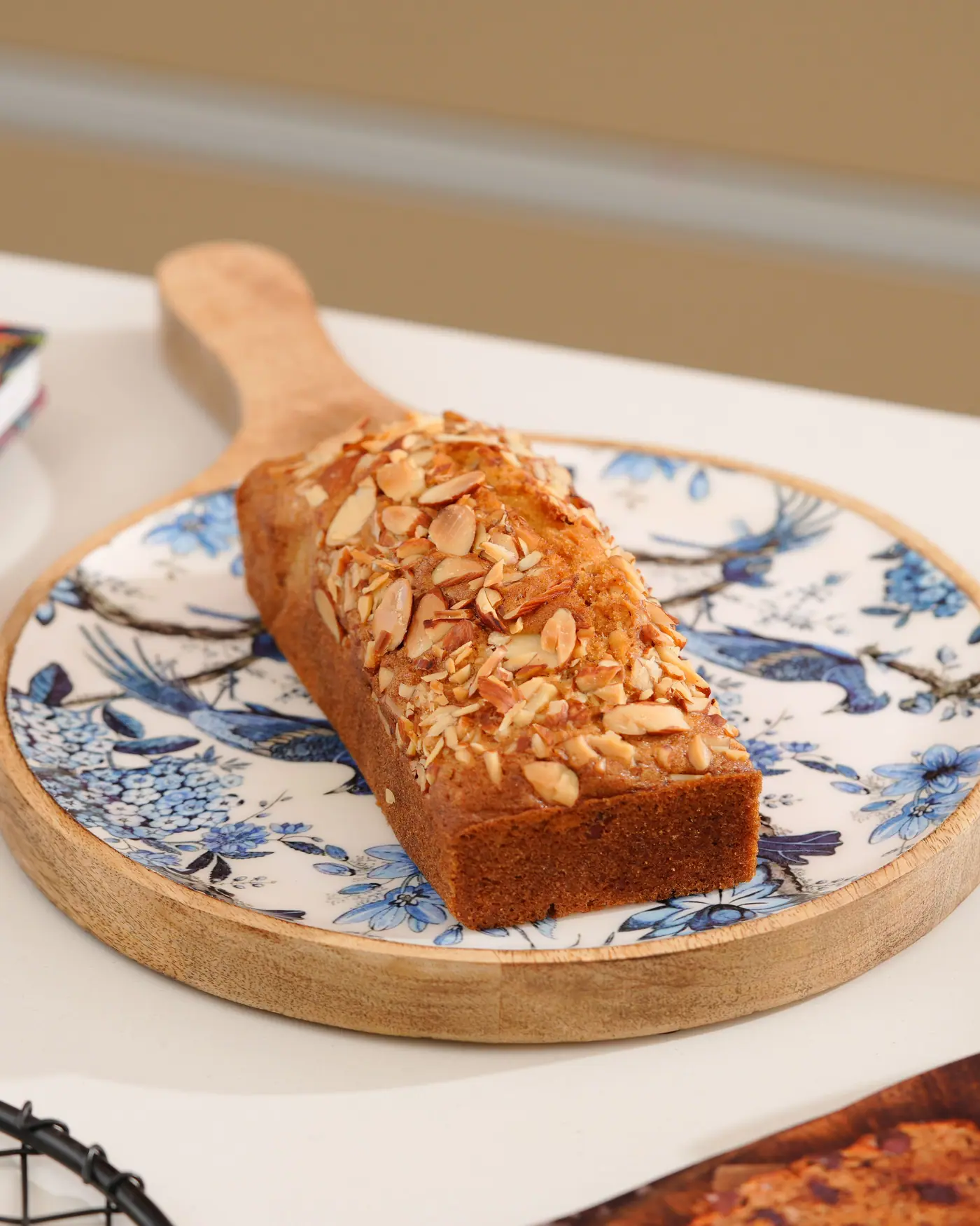 Almond-topped tea cake on a blue and white plate