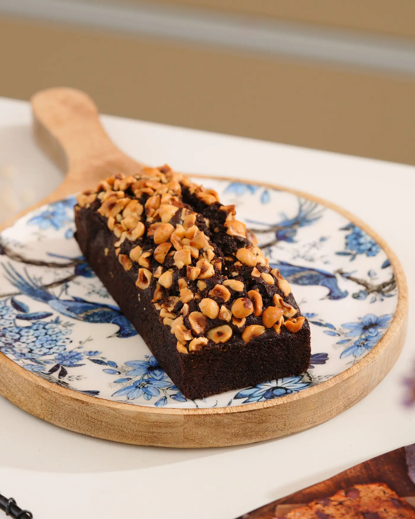 Chocolate tea cake topped with toasted hazelnuts